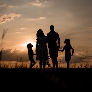 Family silhouette at sunset, symbolising family problem astrology guidance