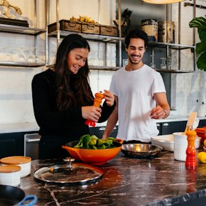 Husband and wife cooking together at home, symbolising husband wife problem solutions