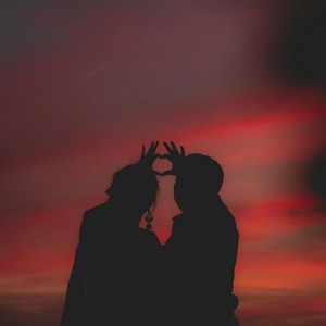Silhouette of a couple forming a heart shape, symbolising love problem astrology guidance